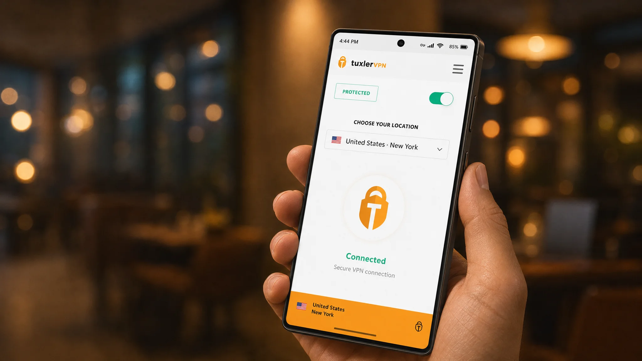 TuxlerVPN Mobile app on an Android phone showing a connected VPN session to a New York gateway, held in hand at a café